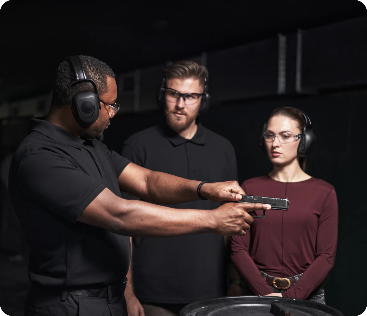 Instructor teaching gun safety at shooting range.