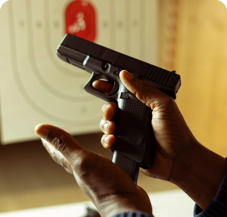 Person holding handgun at shooting range
